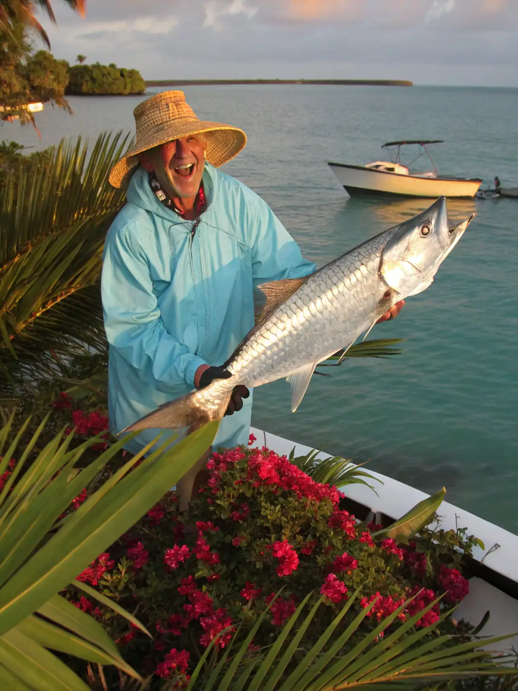 An action shot of an angler battling a large tarpon just off the coast, emphasizing the excitement and challenge of Two For Hooking's nearshore and tarpon fishing charters.